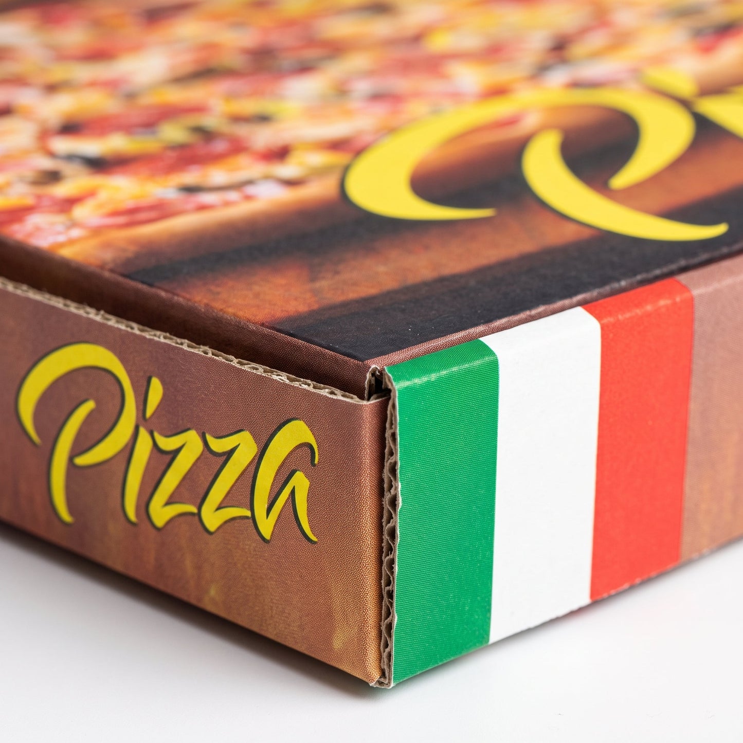 Close up of a printed pizza box corner showing the E-flute corrugated edge